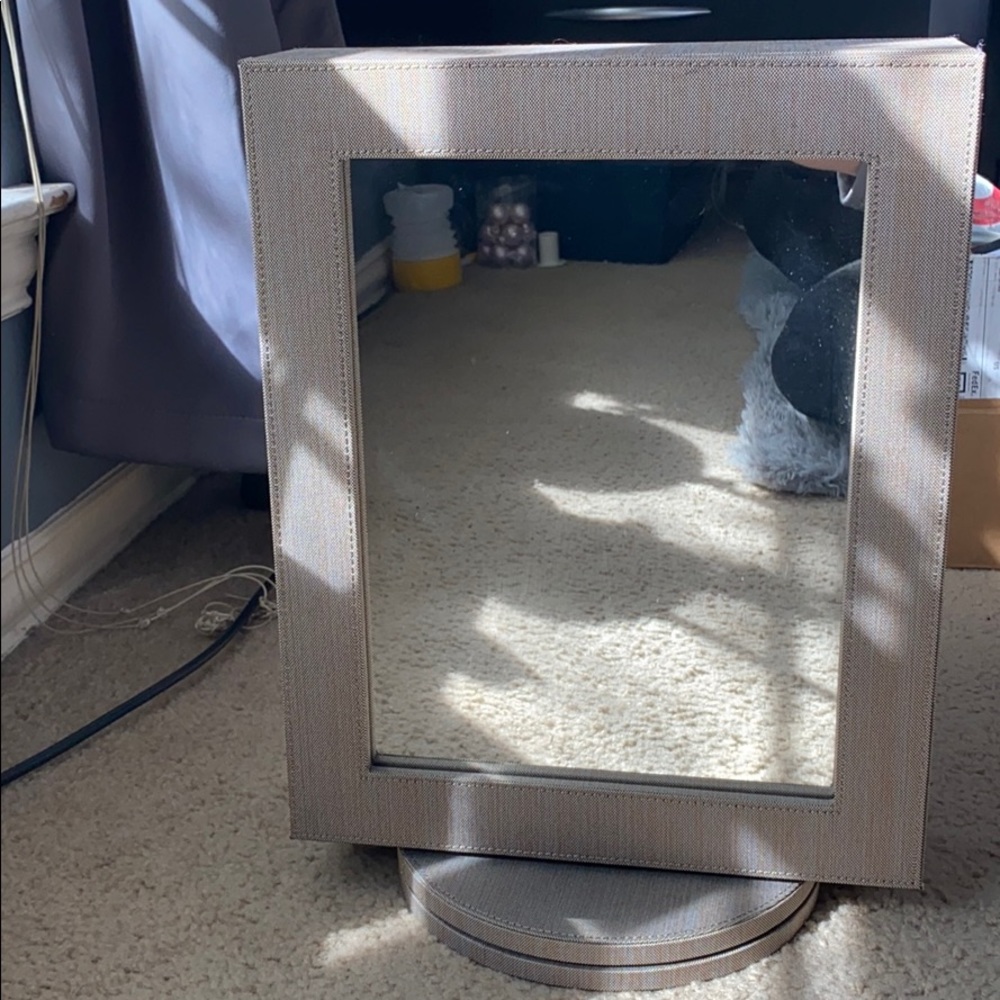 Rotating double sided jewelry holder with a mirror